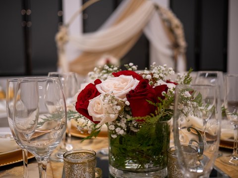 Roses and glassware on a set table